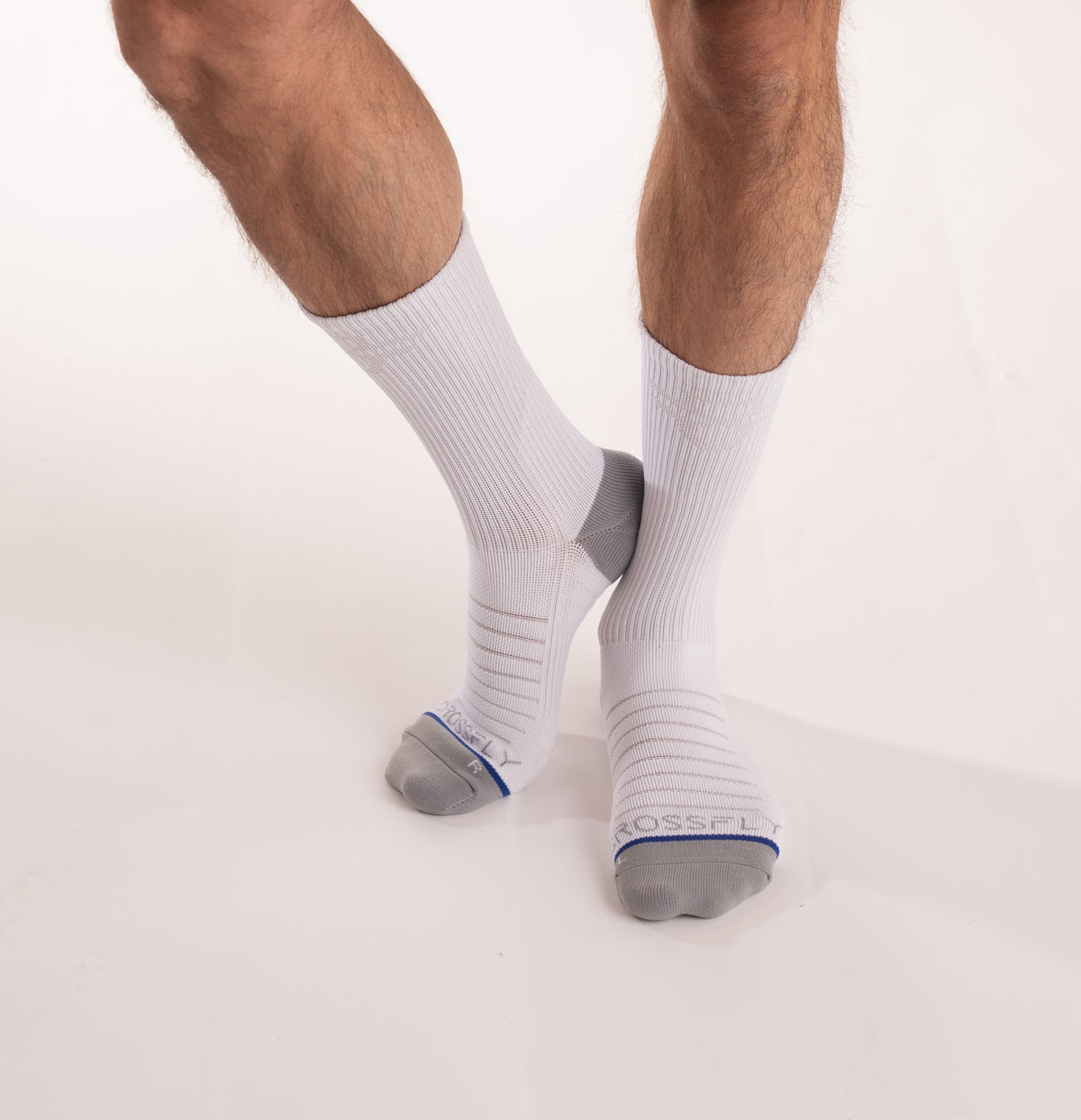 Crossfly men&#39;s Hero Crew Socks in white from the Performance series, featuring AirBeams and 180 Hold.